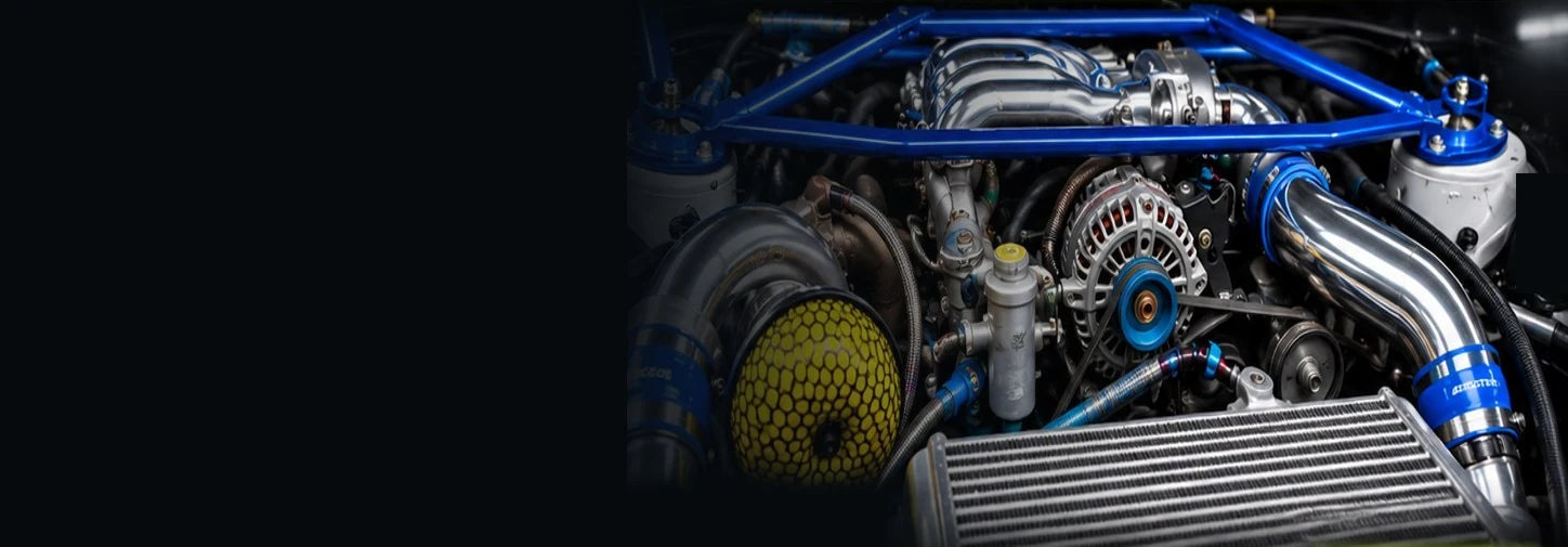 RX-7 engine bay with blue strut brace and polished intake